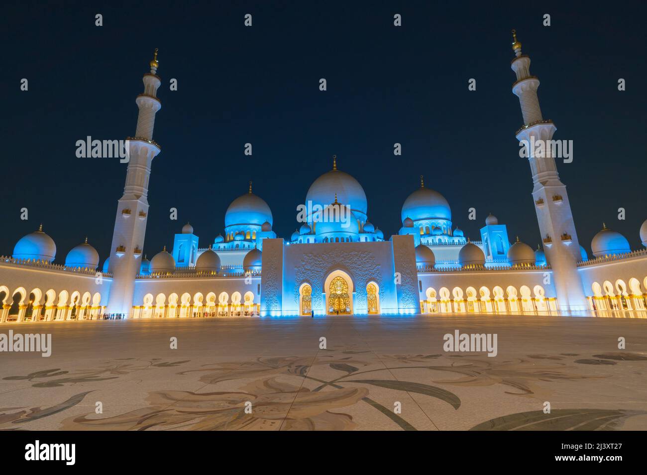 Panoramic view of Sheikh Zayed Grand Mosque, Abu Dhabi, United Arab Emirates. The third biggest mosque in the world.  Night view with blue and yellow Stock Photo