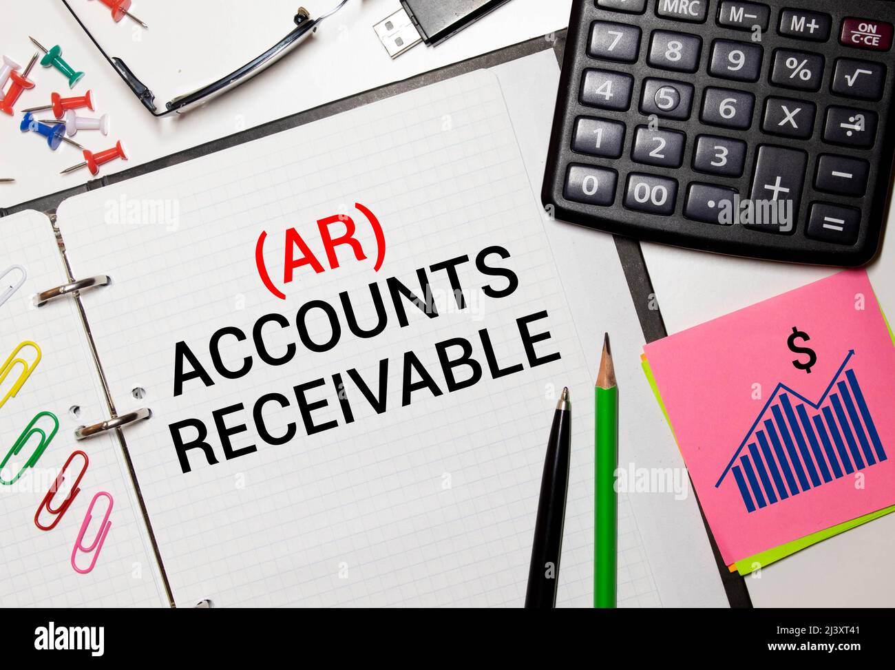 Open book with figures and paper with words accounts receivable Stock Photo Alamy