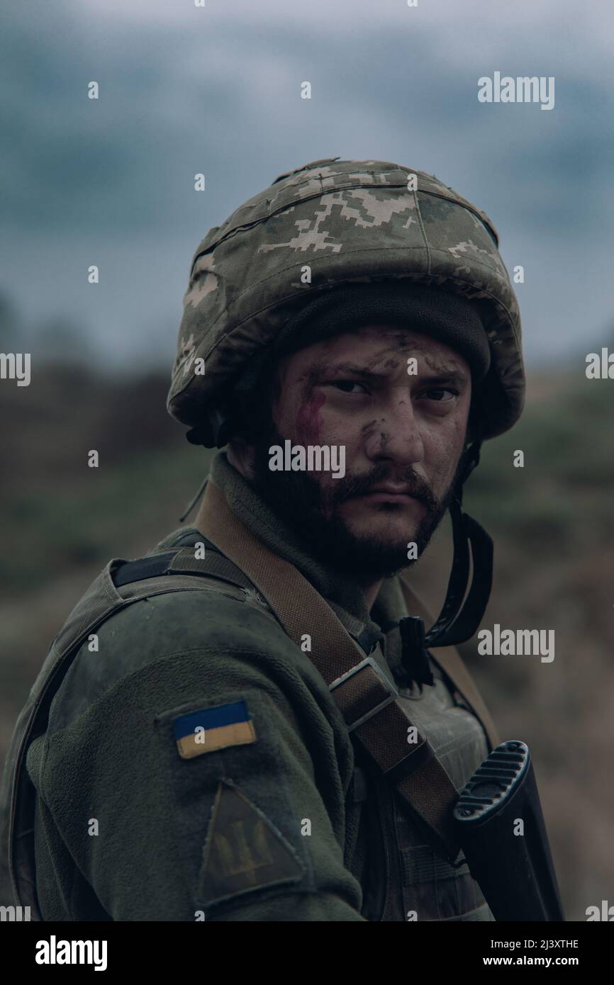 Portrait of Ukrainian soldier in helmet with kalashnikov assault rifle ...