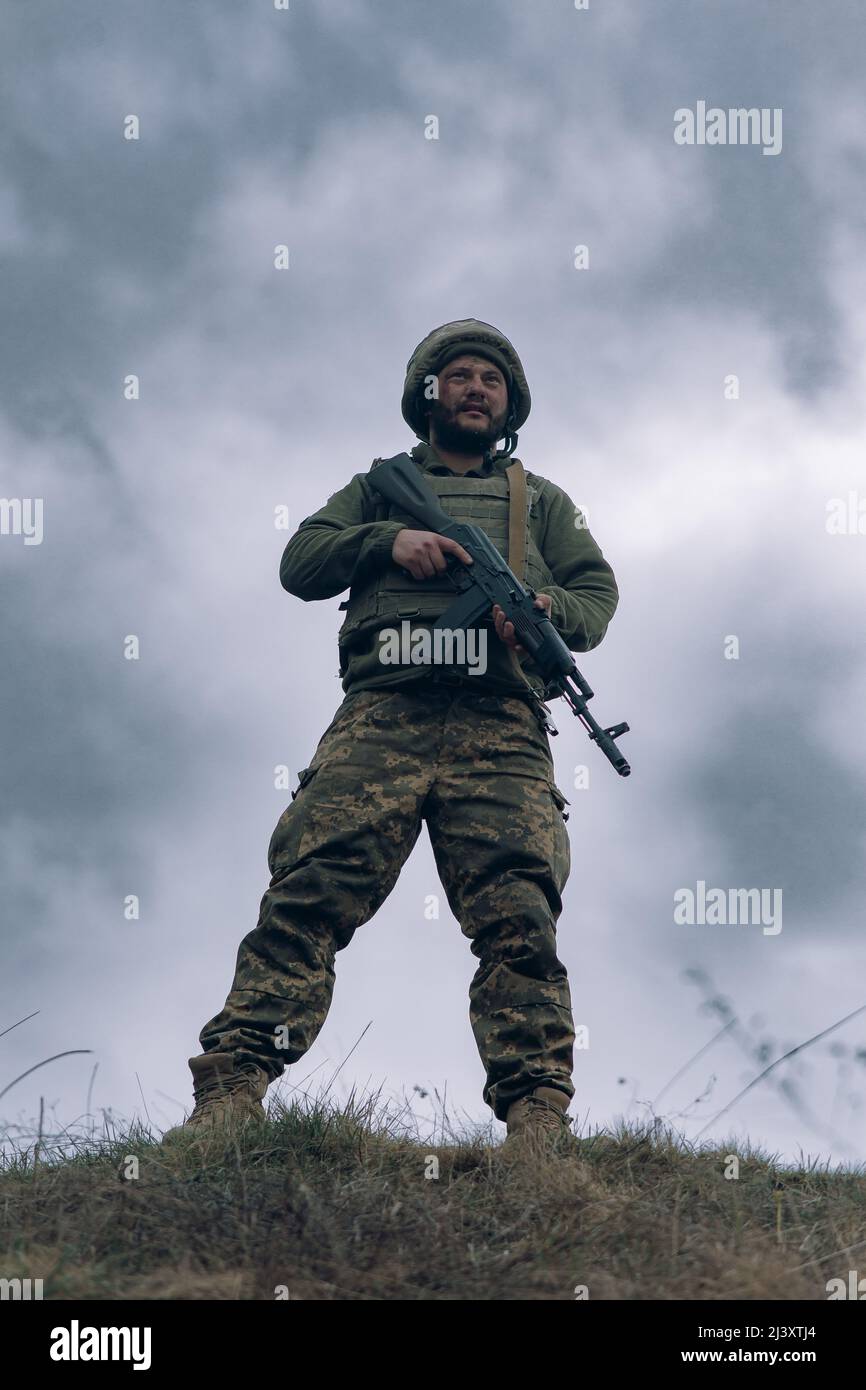 Ukrainian soldier stands with kalashnikov assault rifle in his hands ...