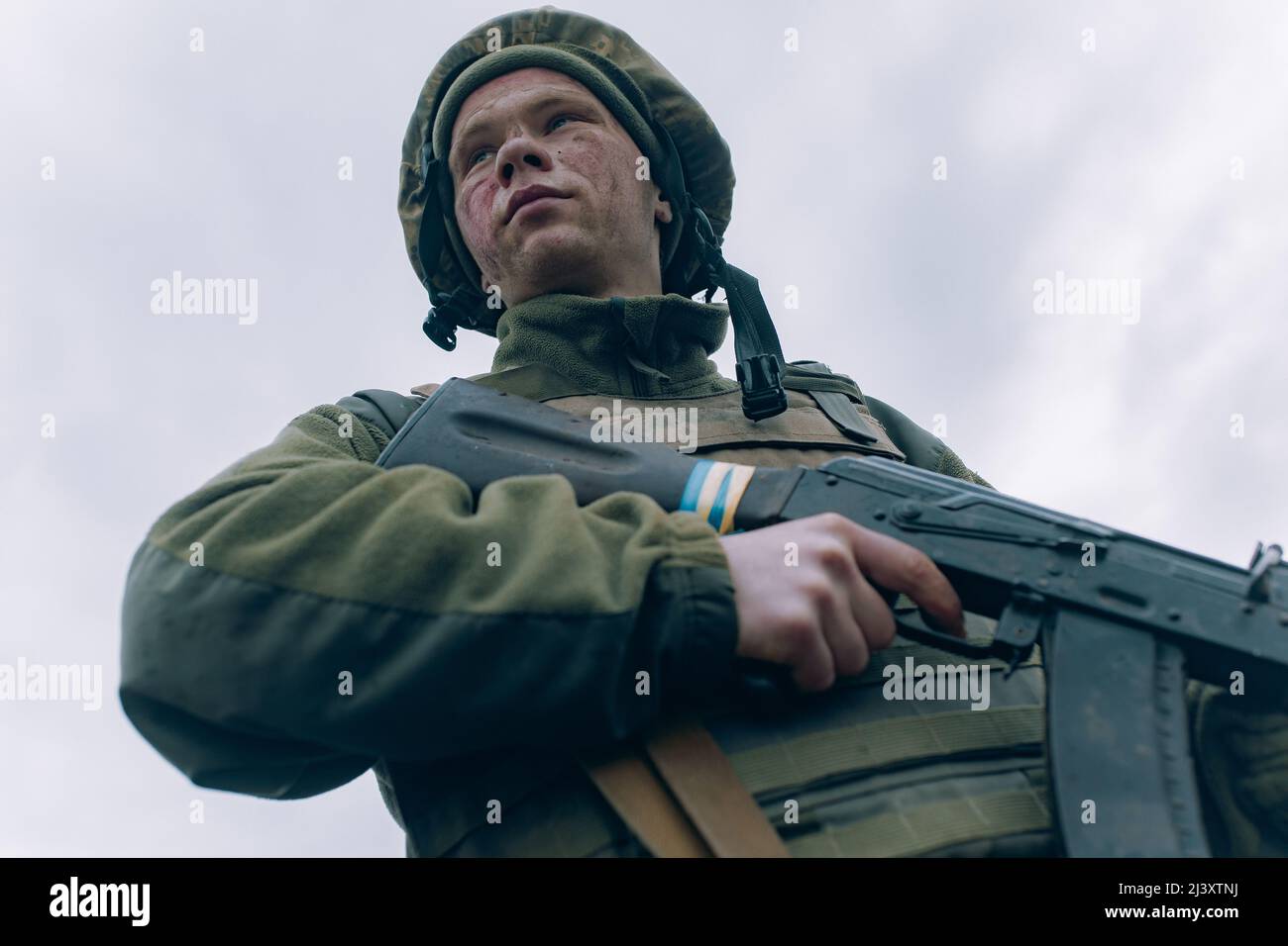 Portrait of Ukrainian soldier in helmet with kalashnikov assault rifle ...