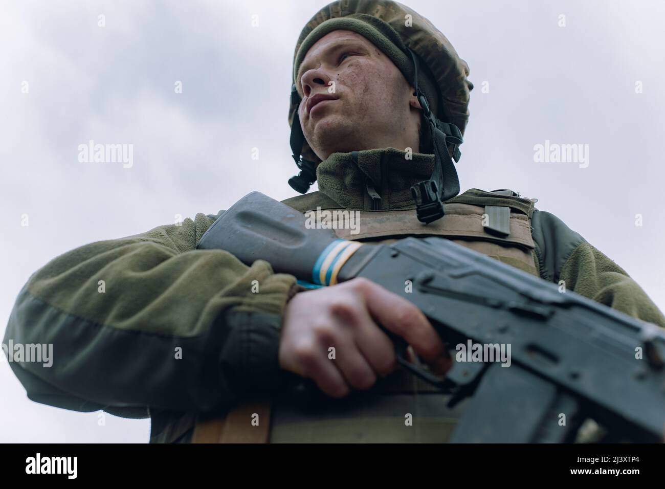 Portrait of Ukrainian soldier in helmet with kalashnikov assault rifle ...