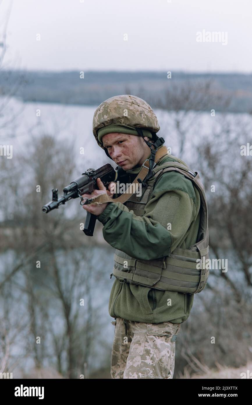 Ukrainian soldier aims from kalashnikov assault rifle to russian enemy ...