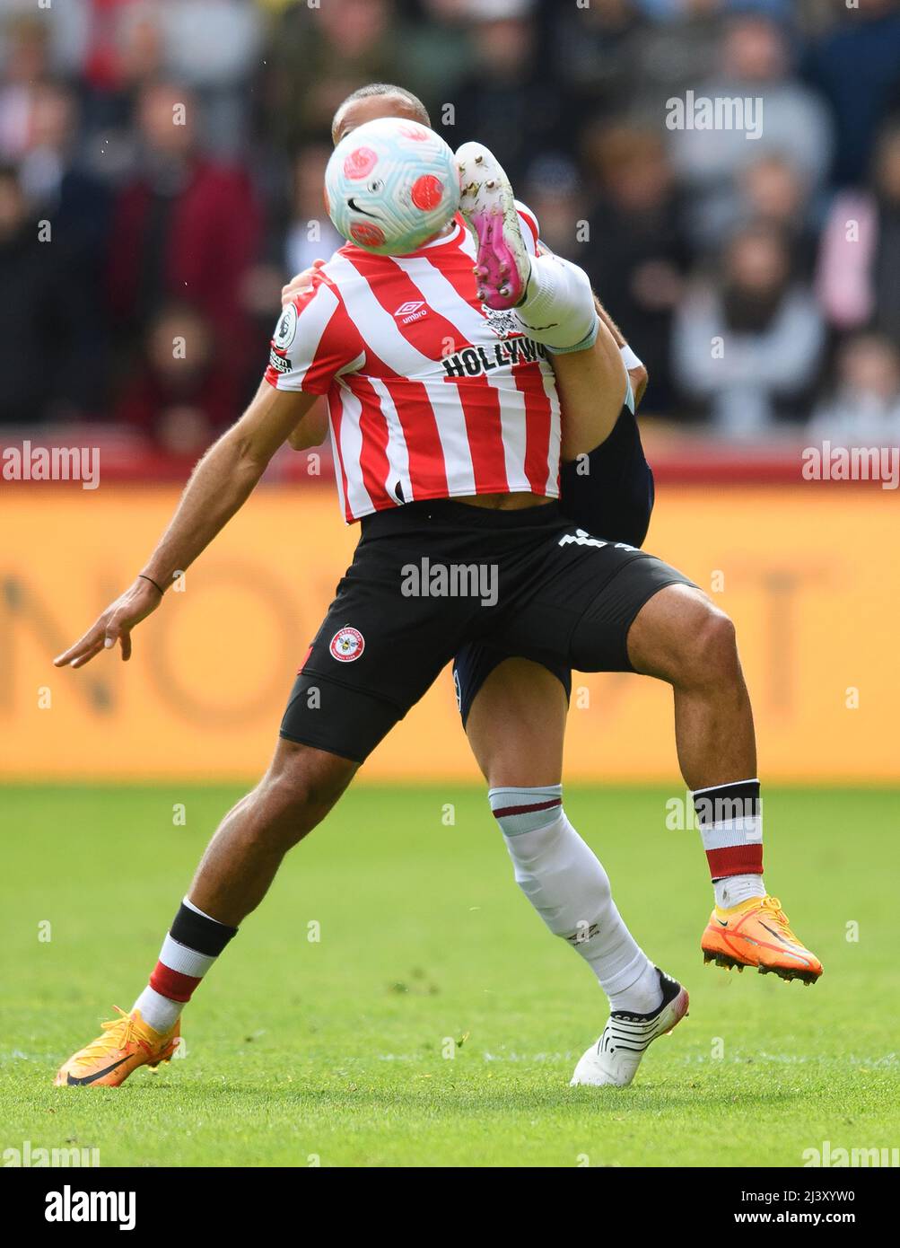 London, UK. 10th Apr, 2022. 10 April 2022 - Brentford v West Ham United - Premier League - Brentford Community Stadium Bryan Mbeumo (hidden) and Aaron Cresswell (hidden!) fight for the ball during the match at the Brentford Community Stadium Picture Credit : Credit: Mark Pain/Alamy Live News Stock Photo
