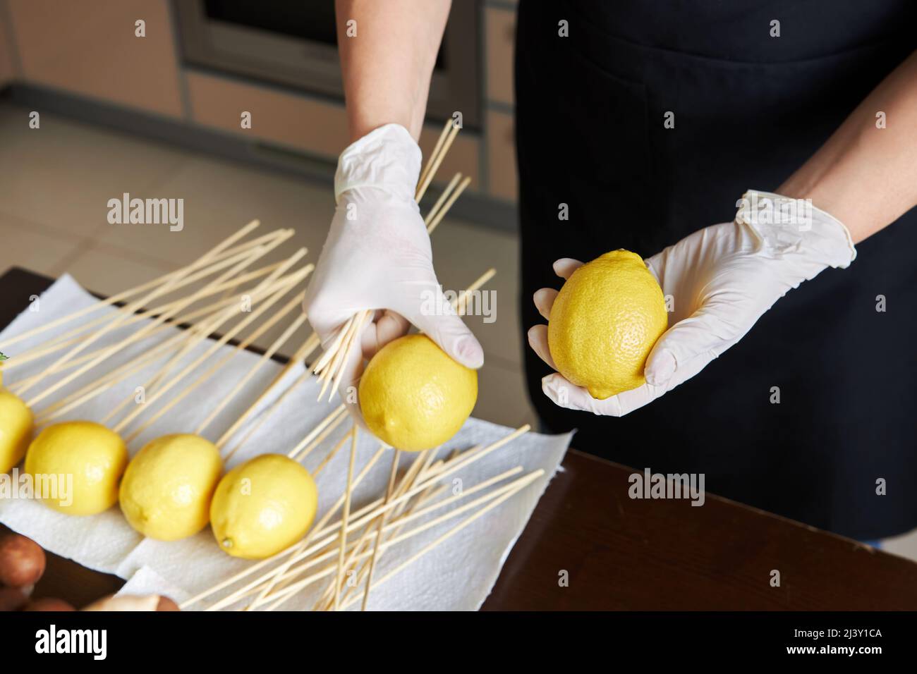 Woman choices the best lemons for her fruit bouquet Stock Photo