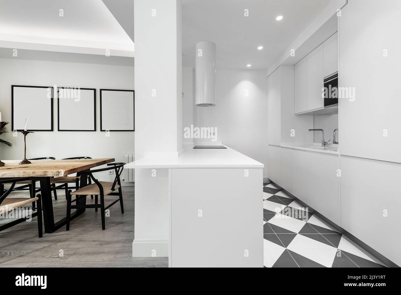 Designer kitchen with soft white lines, integrated appliances and white