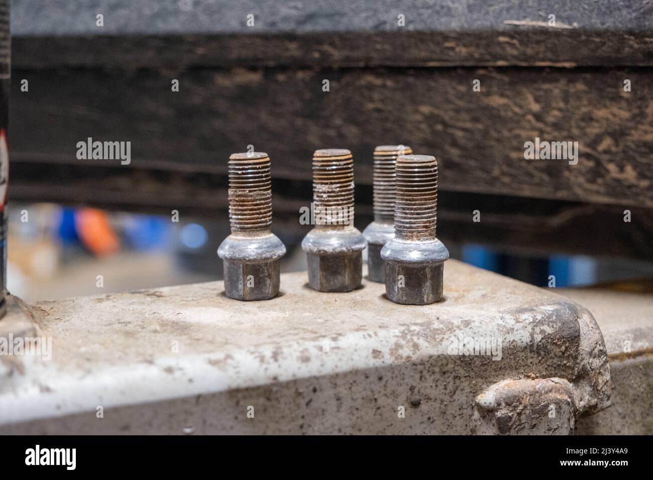 Screw out four car wheel bolts set together Stock Photo Alamy