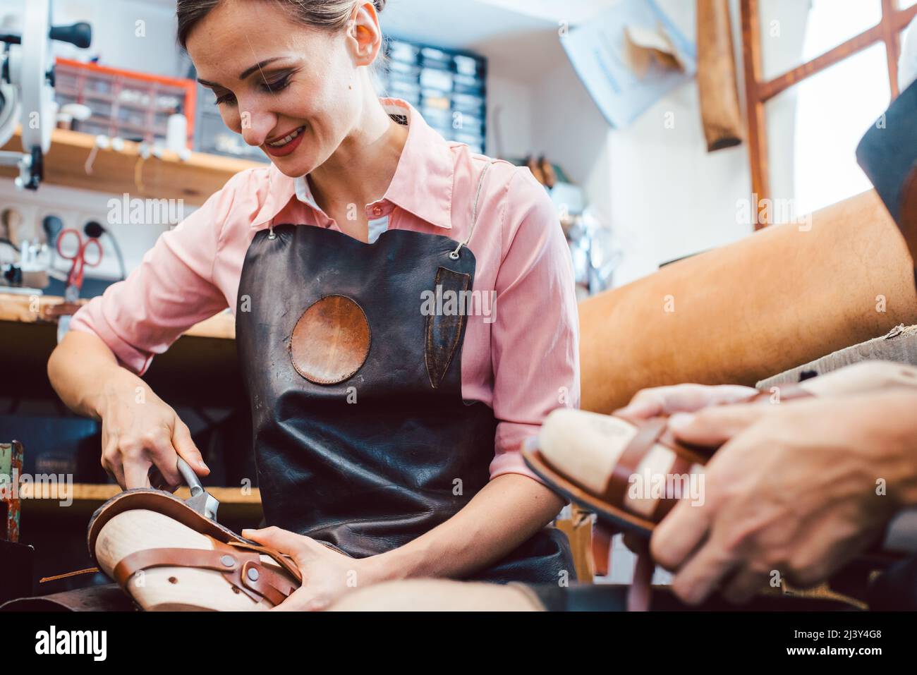 Woman and man shoemaker working together Stock Photo