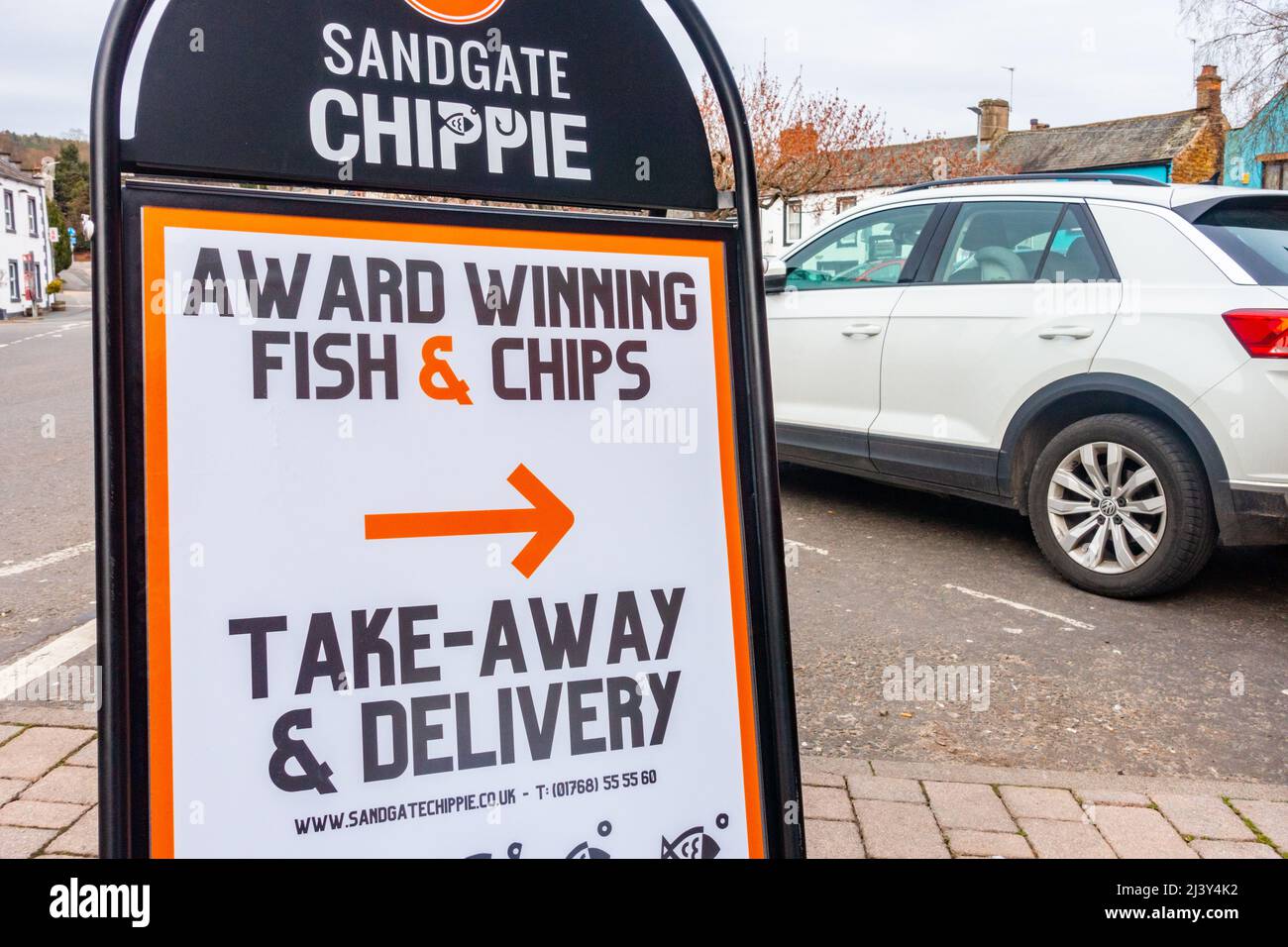 A sign giving directions to Sandgate Chippie in Penrith, Cumbria, UK Stock Photo