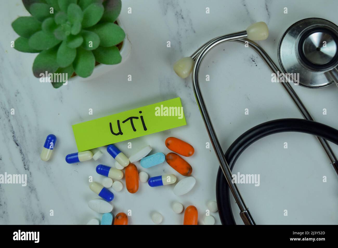 UTI write on sticky notes isolated on Wooden Table. Stock Photo