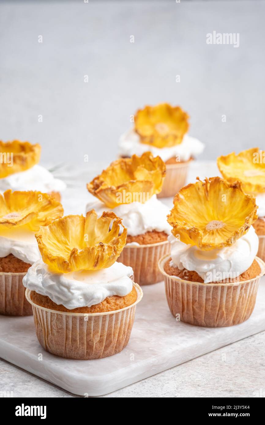 Cupcakes with dried pineapple flowers Stock Photo