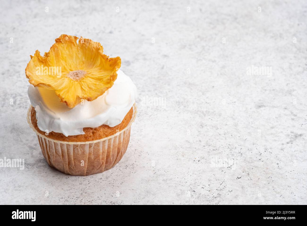 Cupcakes with dried pineapple flowers Stock Photo