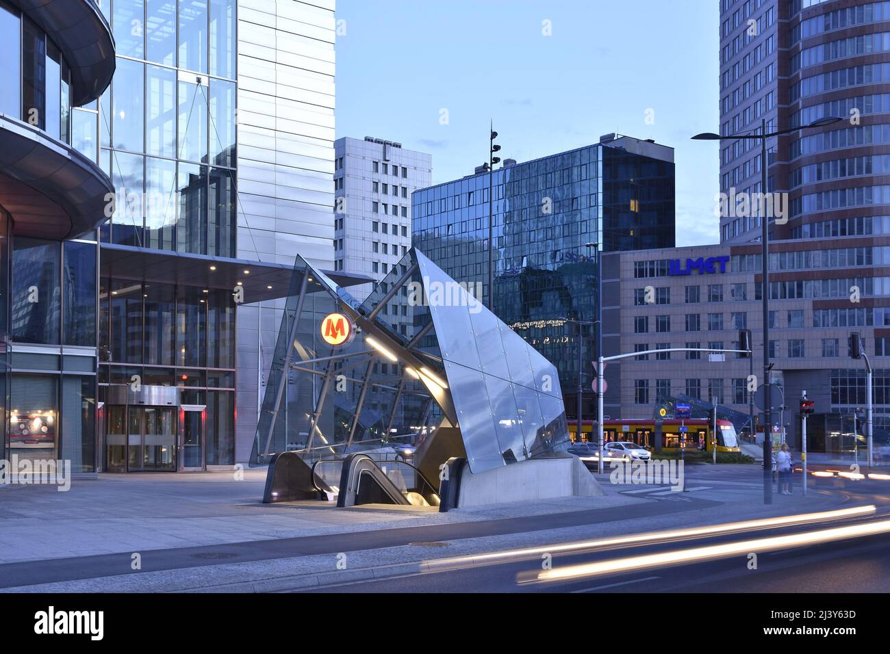 Modern Rondo ONZ metro station entrance and commercial properties at dusk in Warsaw Poland. Stock Photo