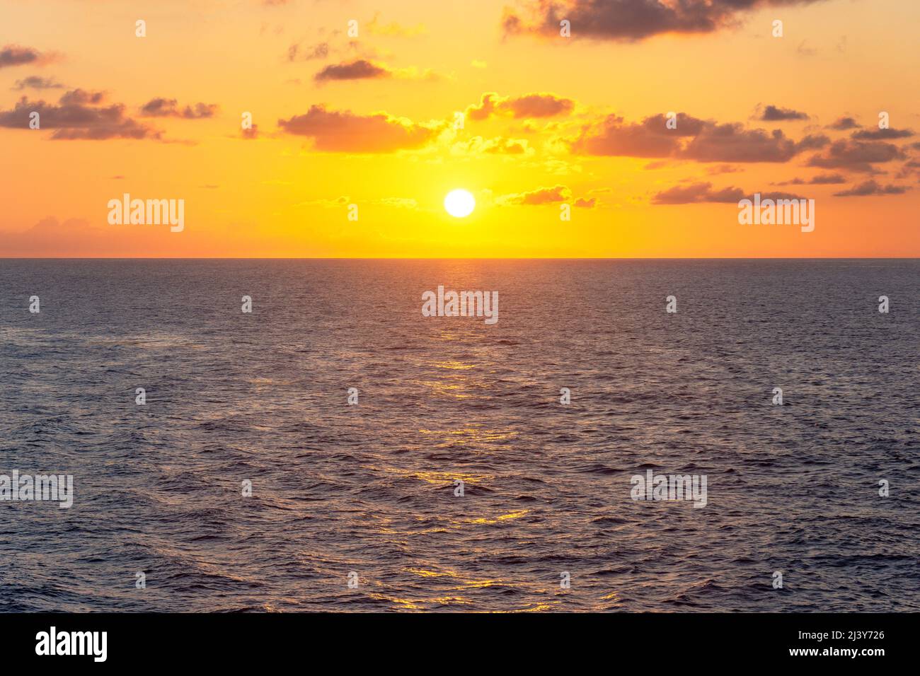 Sun setting over sea from Marella Explorer 2 cruise ship, Caribbean Sea, Caribbean Stock Photo