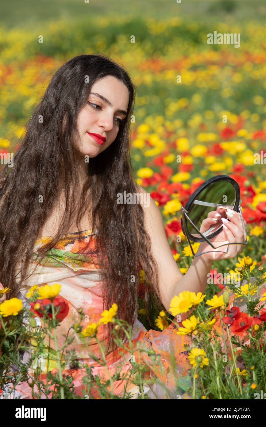 Portrait of a young woman with closed eyes in the field in spring. Stock Photo