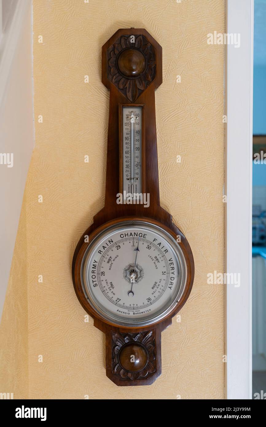 British made antique aneroid barometer with a face showing stormy