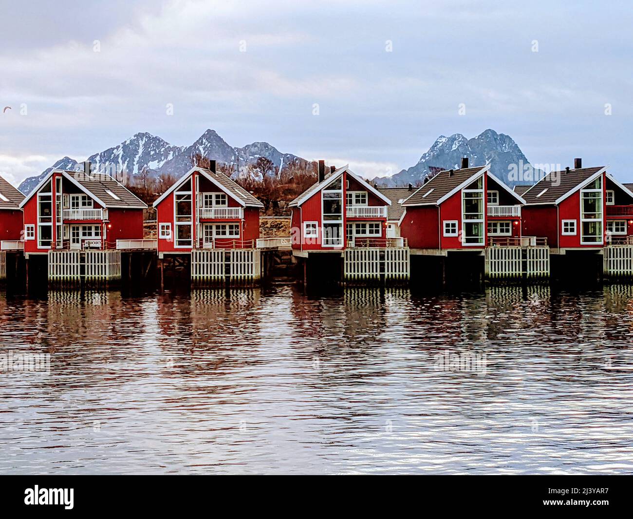 Rorbu cottages in Svolvaer, Lofoten Islands, Norway, with background mountains Stock Photo