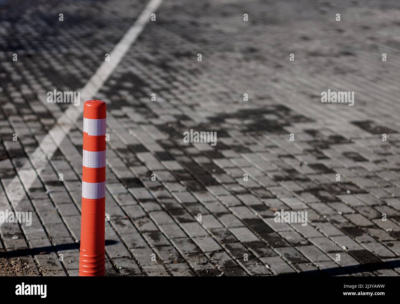 Orange traffic reflective bollards. road barrier. road safety Stock