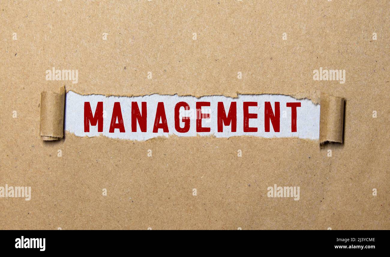 word Management on torn paper Stock Photo