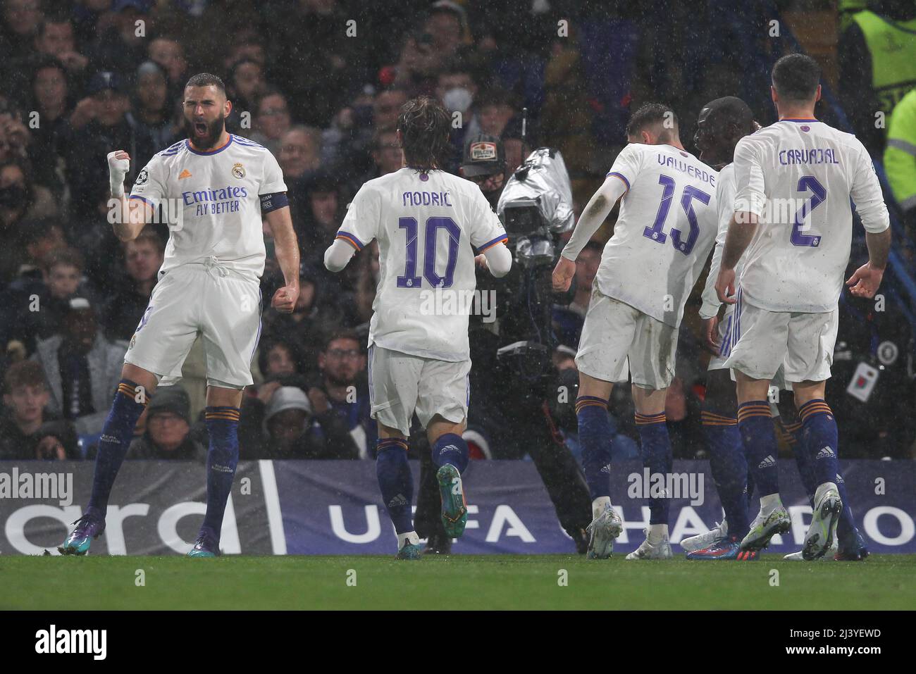 London, UK. 10th Apr, 2022. Karim Benzema of Real Madrid scores the opening  goal to make it 0-1 and celebrates during the UEFA Champions League match  between Chelsea and Real Madrid at