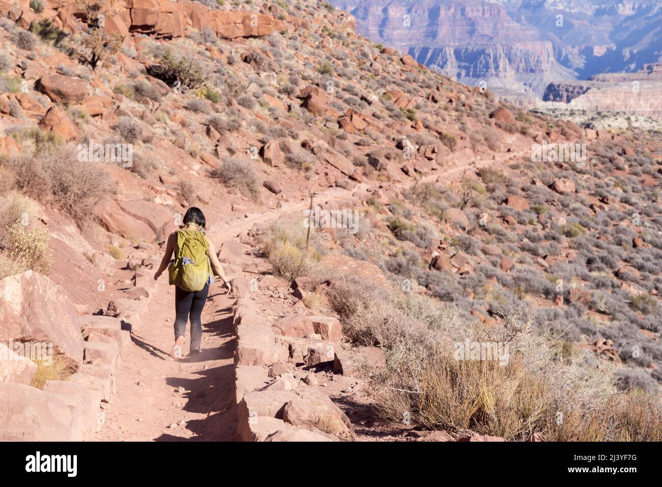 Female Hiker in Athletic Clothing and Backpack Descending South Kaibab Hiking Trail, Grand Canyon National Park Arizona USA Stock Photo