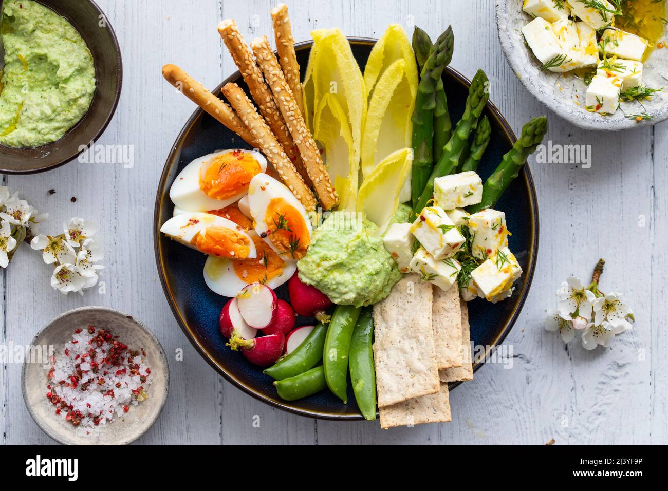 Easter sharing platter with eggs, asparagus, crunchy vegetables and feta Stock Photo