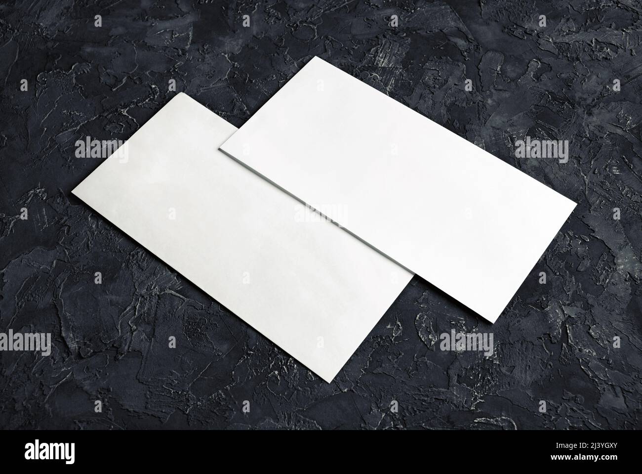 Blank paper envelopes on black plaster background. Template for your design. Stock Photo