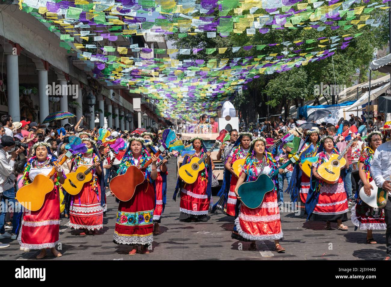 Uruapan, Mexico. 10th Apr, 2022. Mexican artisans from Paracho, known as the guitar city, parade down the street marking the start of the Palm Sunday Handcraft Market or Tianguis de Domingo de Ramos April 9, 2022 in Uruapan, Michoacan, Mexico. The village of Paracho, was the inspiration for the hit Disney movie ‘Coco'. Credit: Richard Ellis/Richard Ellis/Alamy Live News Stock Photo