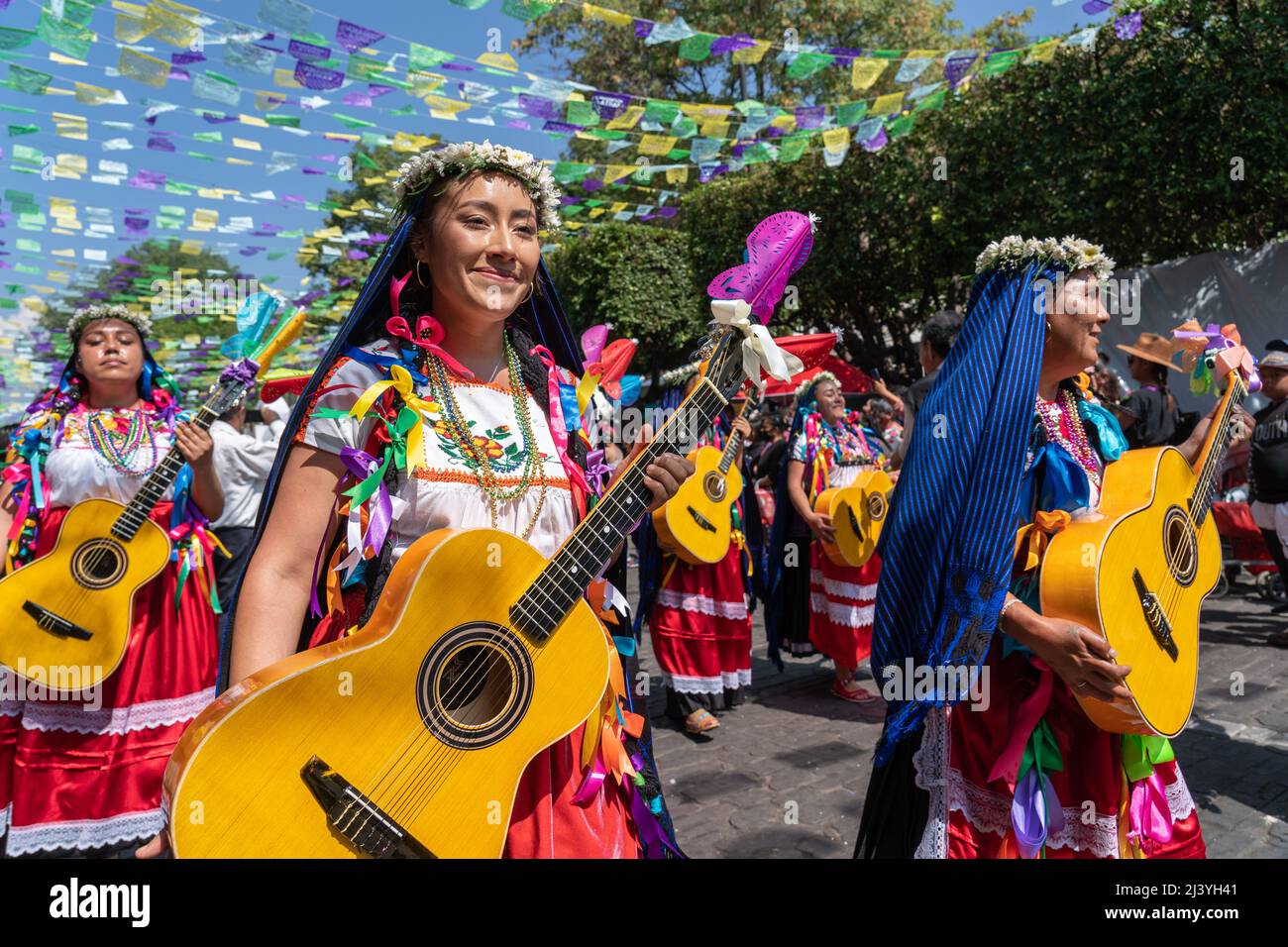Uruapan, Mexico. 10th Apr, 2022. Mexican artisans from Paracho, known as the guitar city, parade down the street marking the start of the Palm Sunday Handcraft Market or Tianguis de Domingo de Ramos April 9, 2022 in Uruapan, Michoacan, Mexico. The village of Paracho, was the inspiration for the hit Disney movie ‘Coco'. Credit: Richard Ellis/Richard Ellis/Alamy Live News Stock Photo