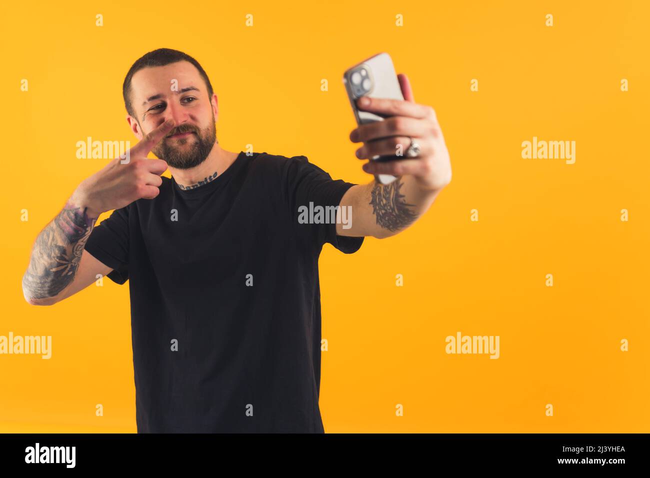 Bearded European guy with tattoo sleeves taking a selfie with his ...