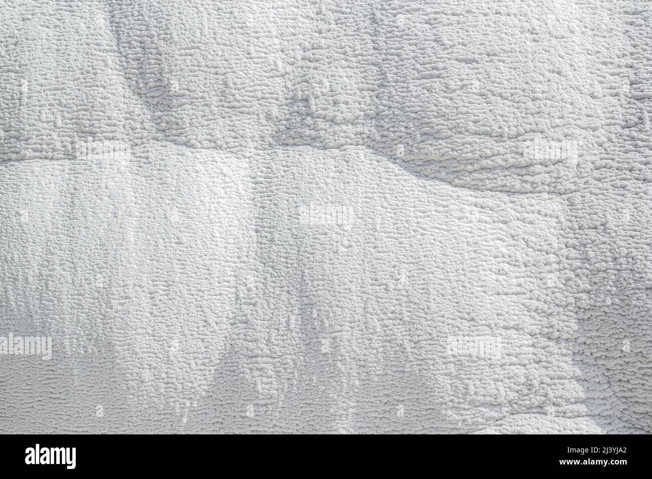 Stone texture covered with calcium deposits. Pamukale texture. Light