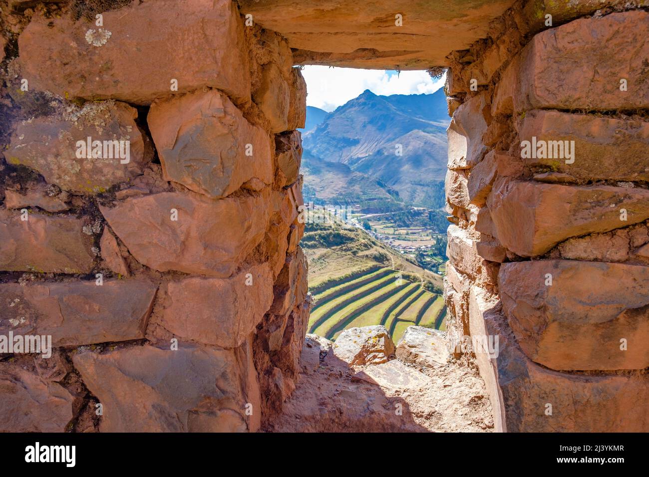 Window showing stonework and agricultural terraces at Pisac Q'Allaqasa (Citadel) sector of Pisac Inca fortress ruins, Peru Sacred Valley. Stock Photo
