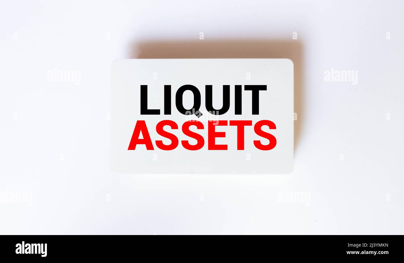 Conceptual hand writing showing Liquid Assets. Business photo text Cash and Bank Balances Market Liquidity Deferred Stock Open notebook squared page b Stock Photo