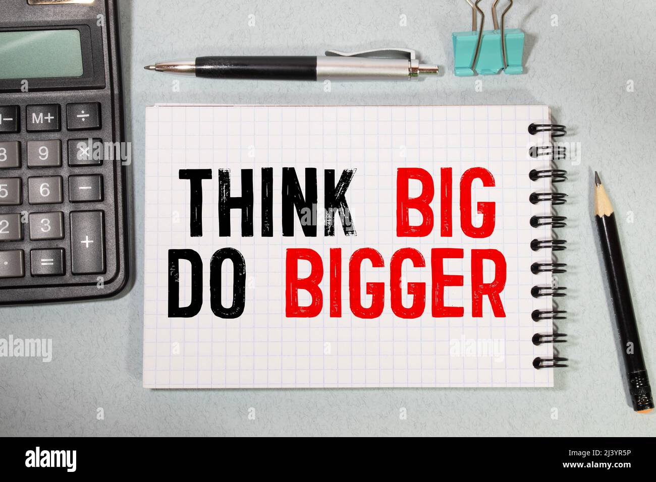Think Big, Do Bigger Motivation quote written on a note paper Stock Photo Alamy