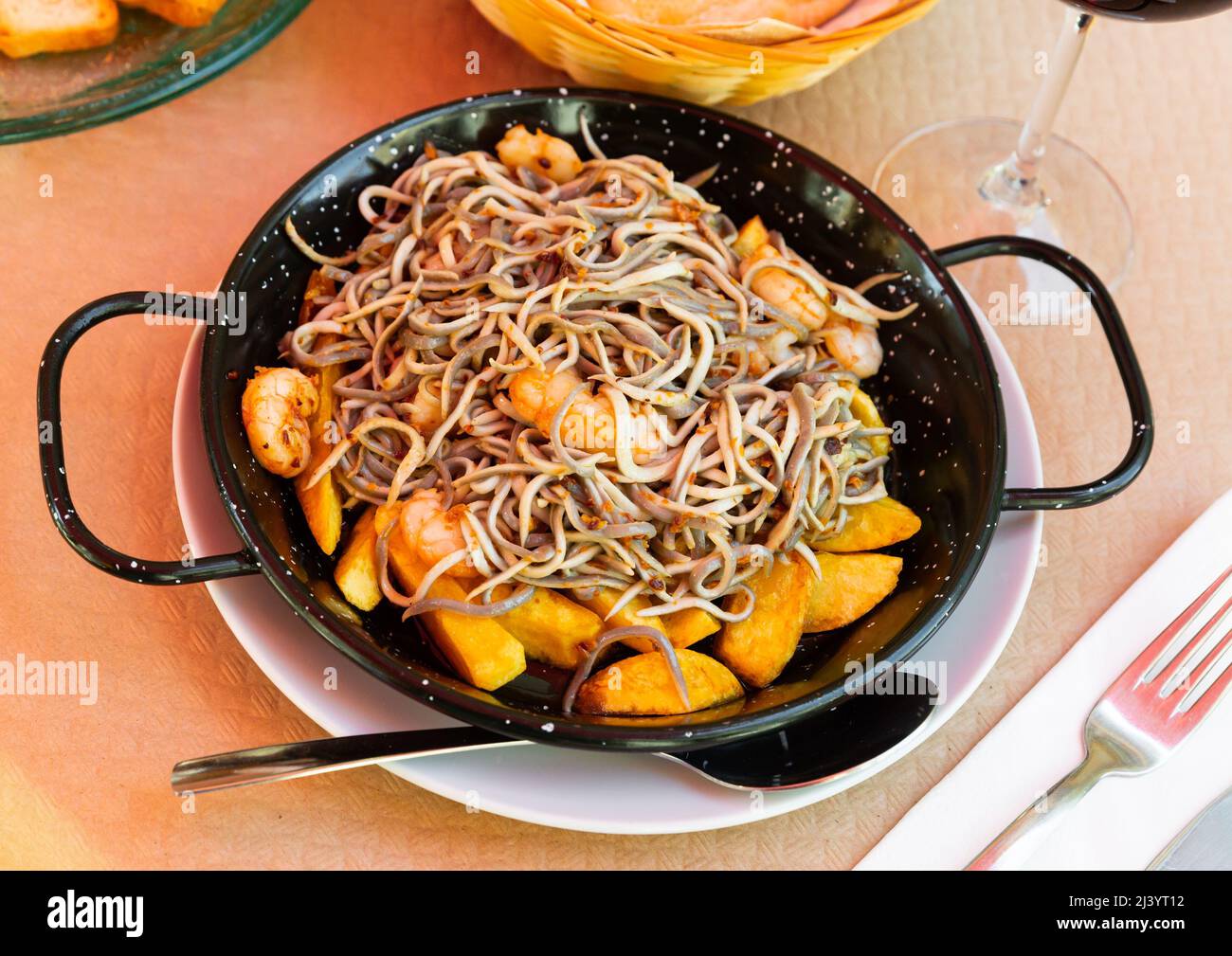 Plate of tasty fried baby eels and prawns with potatoes Stock Photo Alamy
