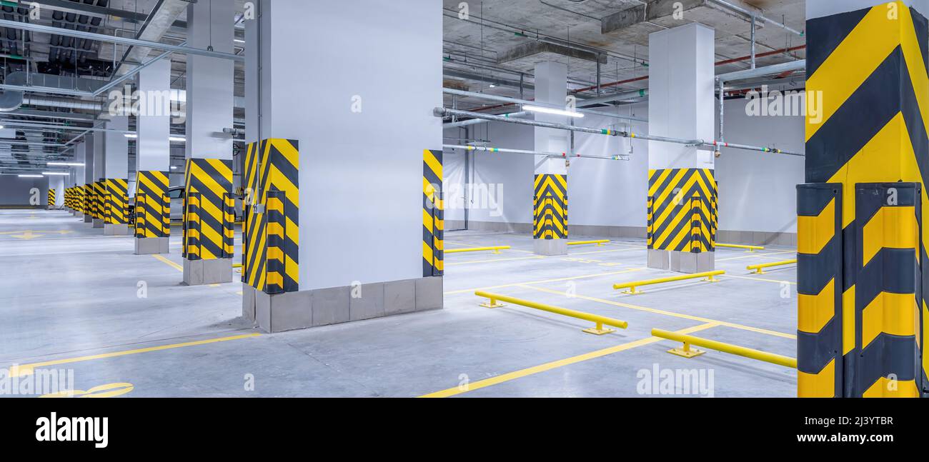Empty shopping mall underground parking lot or garage interior with ...