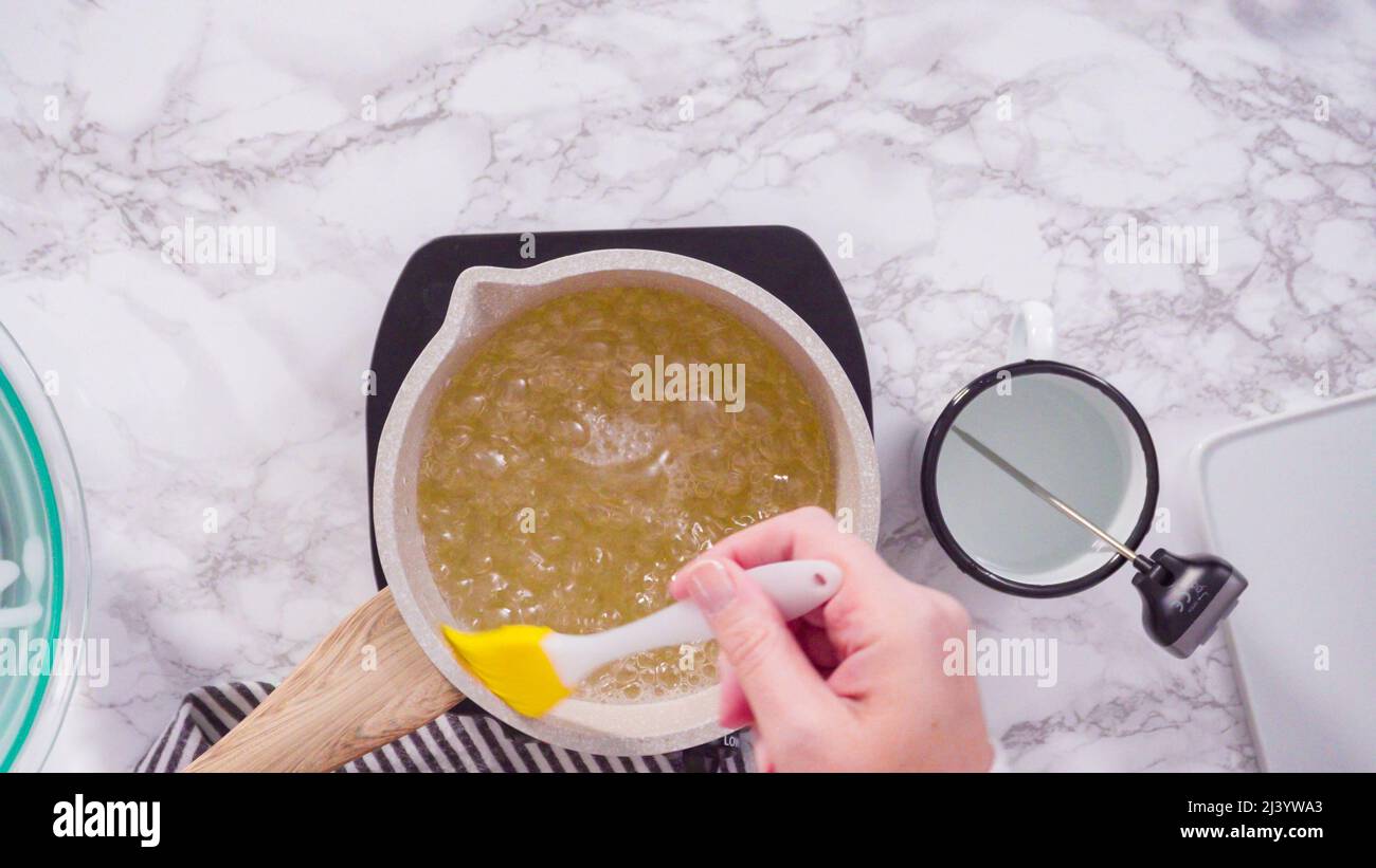 Flat lay. Step by step. Caramelizing sugar in a small cooking pot over ...
