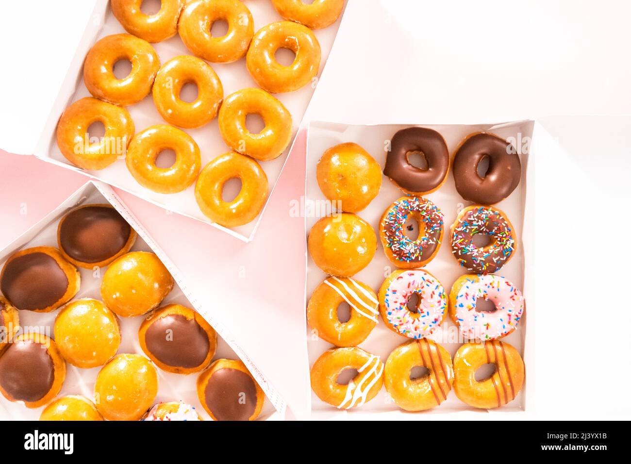 Flat lay. Variety of storebought doughnuts in a white paper box Stock