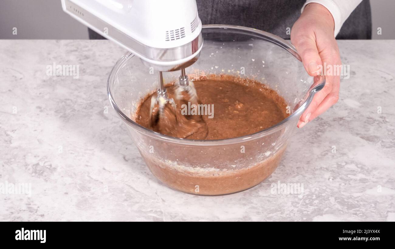Step by step. Mixing ingredients in a glass mixing bowl to prepare red