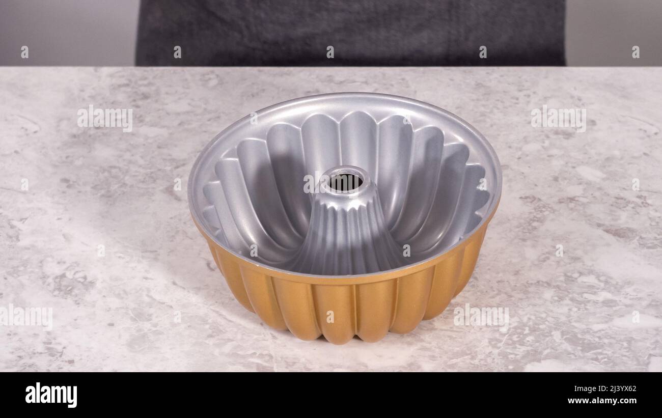 Step by step. Greasing bundt cake pan with vegetable shortening and