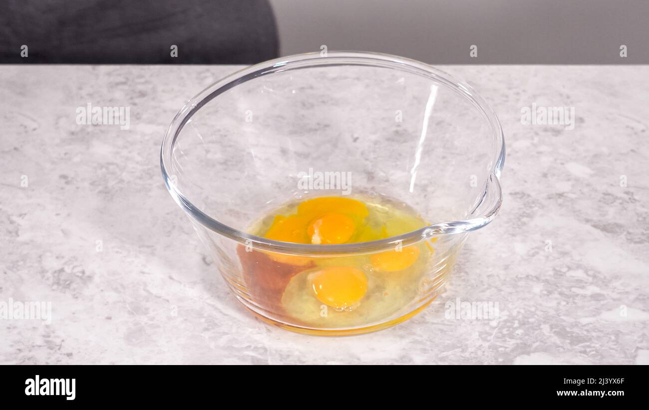Step by step. Mixing ingredients in a glass mixing bowl to prepare red