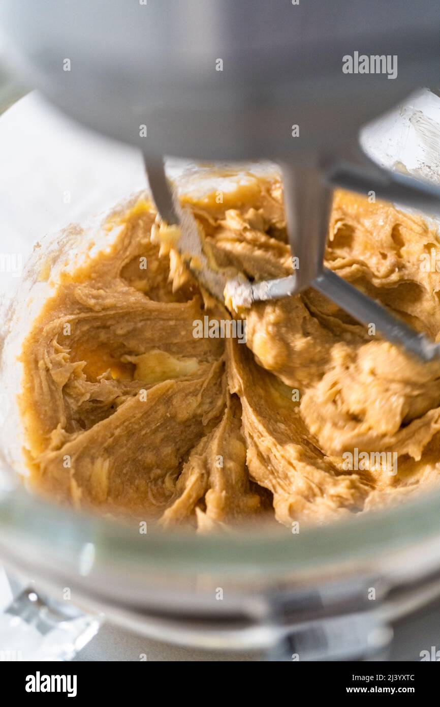 Mixing ingredients in a kitchen stand mixer to bake soft oatmeal raisin