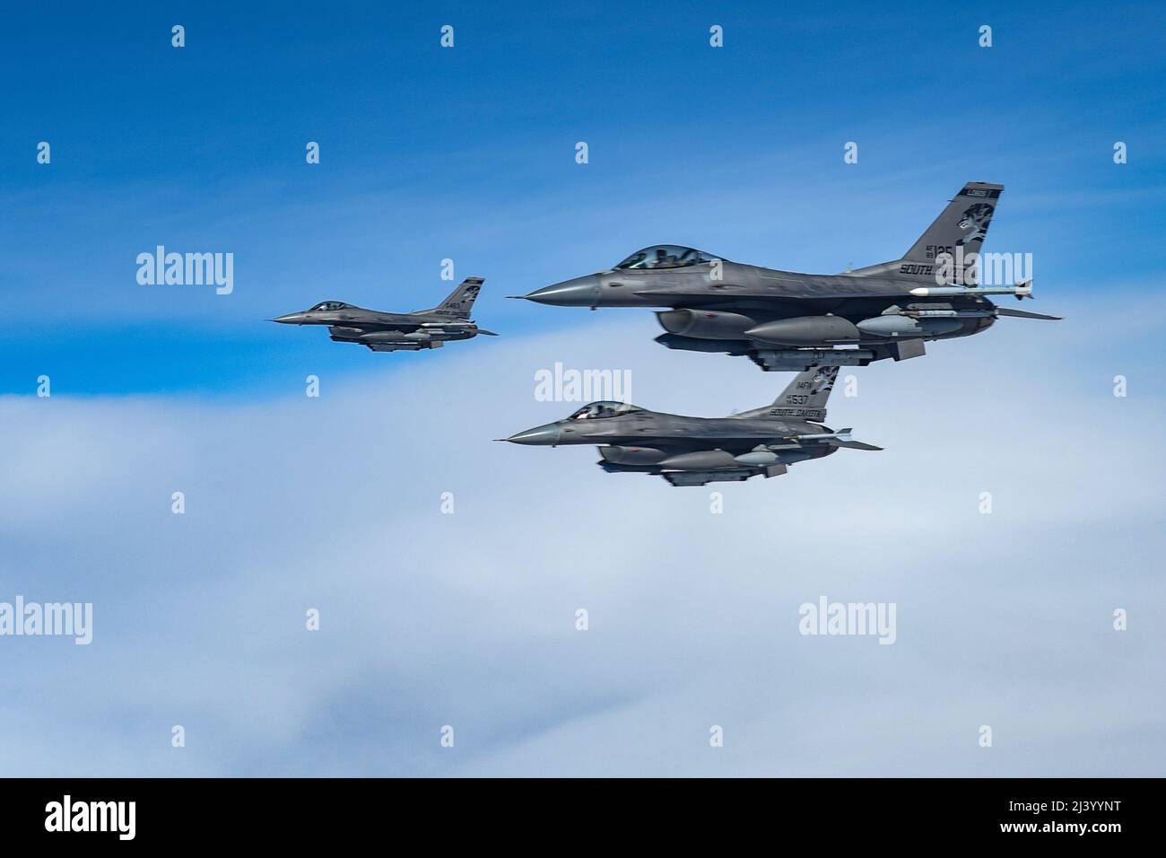 Three F-16 Fighting Falcons assigned to the 114th Fighter Wing, fly alongside of a KC-135 Stratotanker from the 185th Air Refueling Wing, while traveling to Weapons and Tactics Instructor (WTI) course 2-22 at Marine Corps Air Station Yuma, Ariz., April 1, 2022. WTI is a seven-week training event hosted by Marine Aviation Weapons and Tactics Squadron One (MAWTS-1), providing standardized advanced tactical training and certification of unit instructor qualifications to support Marine aviation training and readiness, and assists in developing and employing aviation weapons and tactics.  (U.S. Air Stock Photo