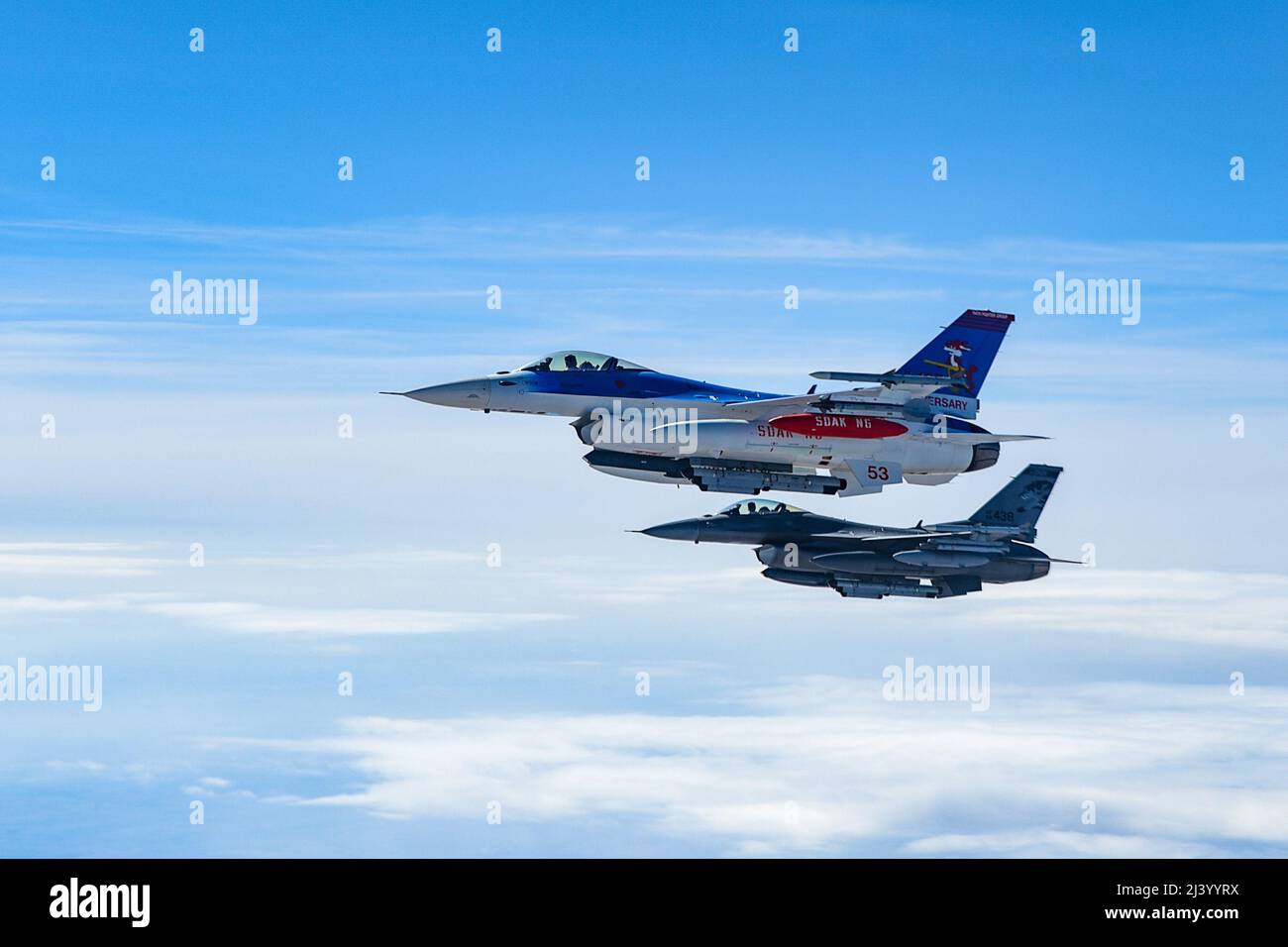 Two F-16 Fighting Falcons assigned to the 114th Fighter Wing, fly alongside of a KC-135 Stratotanker from the 185th Air Refueling Wing, while traveling to Weapons and Tactics Instructor (WTI) course 2-22 at Marine Corps Air Station Yuma, Ariz., April 1, 2022. WTI is a seven-week training event hosted by Marine Aviation Weapons and Tactics Squadron One (MAWTS-1), providing standardized advanced tactical training and certification of unit instructor qualifications to support Marine aviation training and readiness, and assists in developing and employing aviation weapons and tactics.  (U.S. Air N Stock Photo