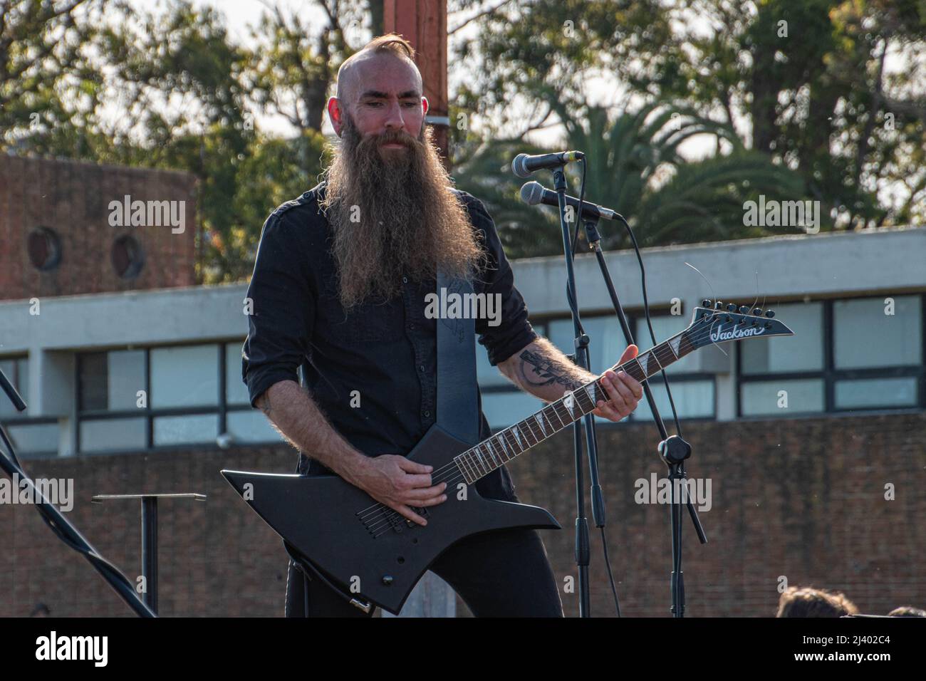 Beard rocker playing guitar and singing Stock Photo - Alamy