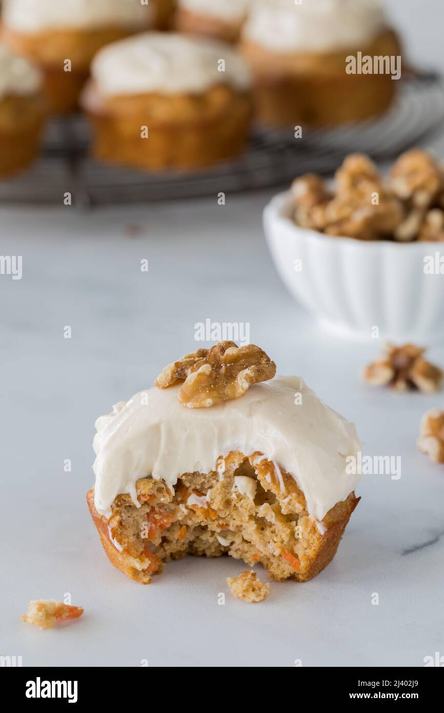A close up of a delicious carrot cake muffin with a bite out. Stock Photo