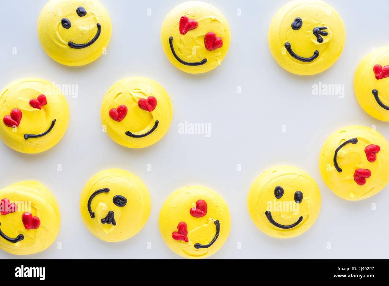 Smiley face emoticon merengue cookies with copy space in the middle. Stock Photo