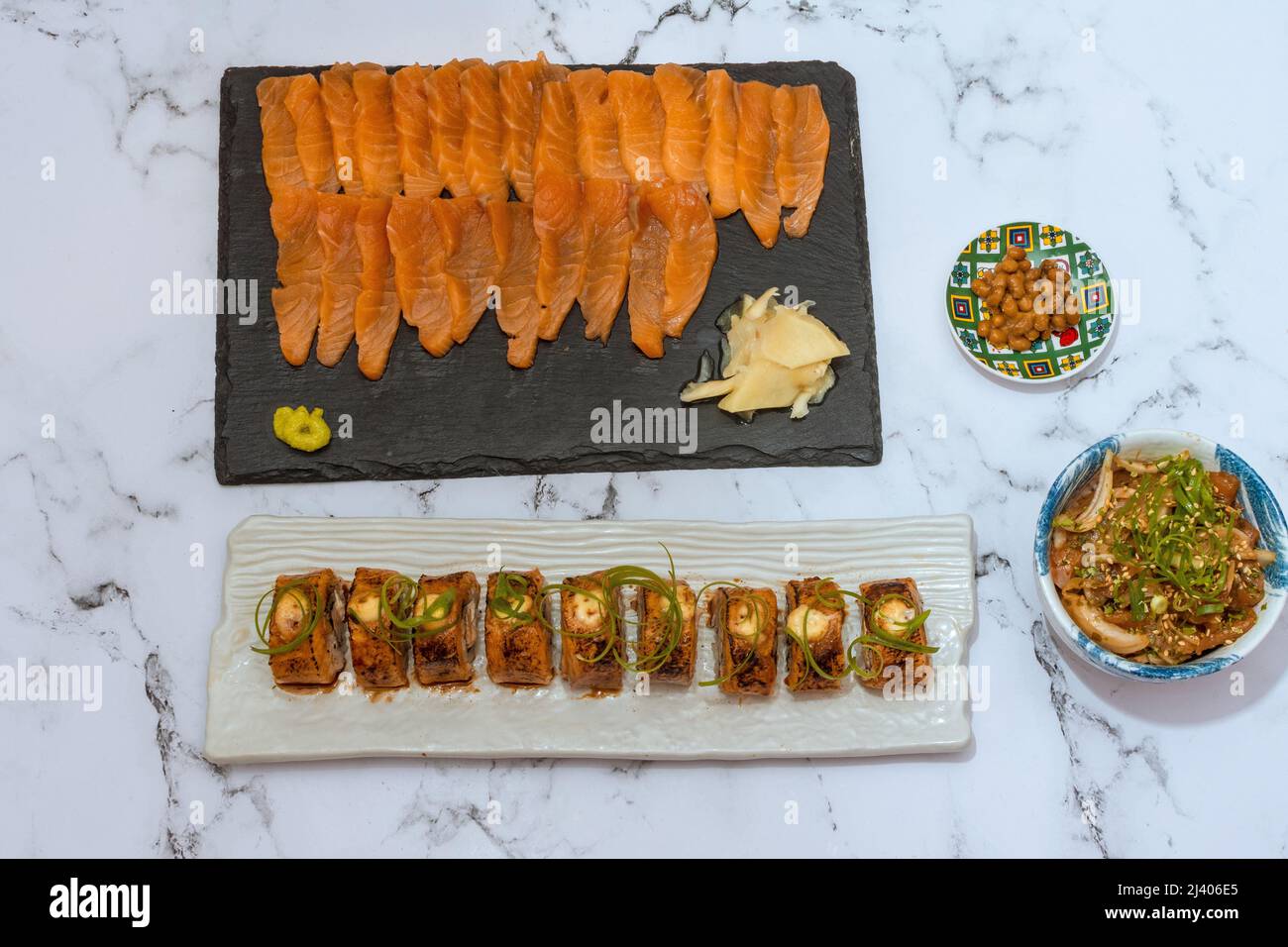 Salmon Sushi Rolls Platted On A White Marble Table. Image can be utilized editorially or commercially. Stock Photo