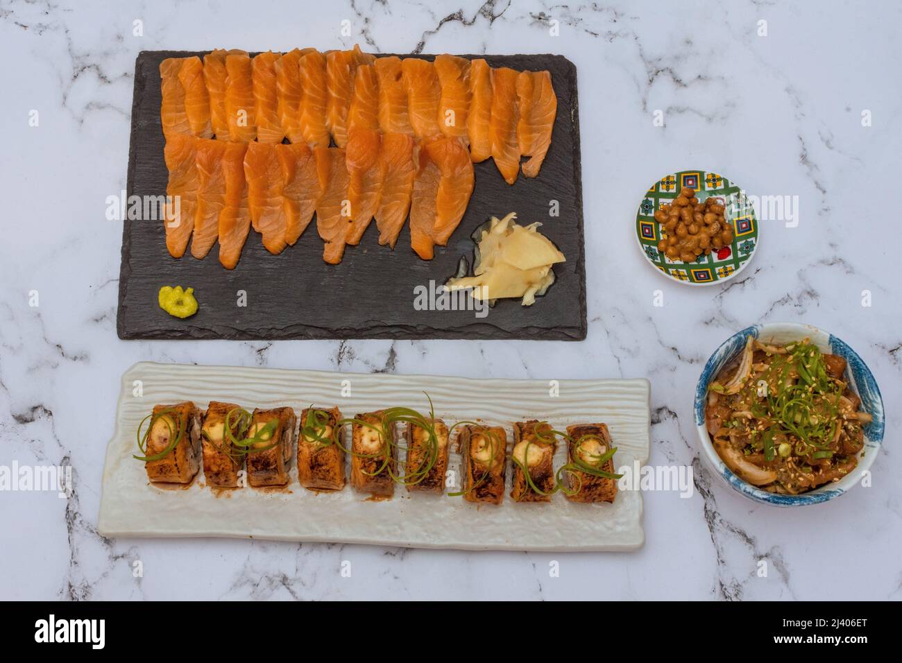 Salmon Sushi Rolls Platted On A White Marble Table. Image can be utilized editorially or commercially. Stock Photo