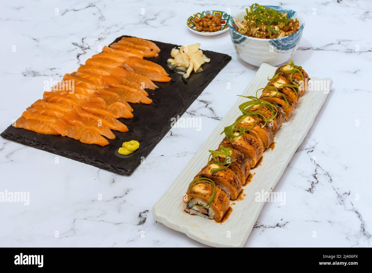 Salmon Sushi Rolls Platted On A White Marble Table. Image can be utilized editorially or commercially. Stock Photo